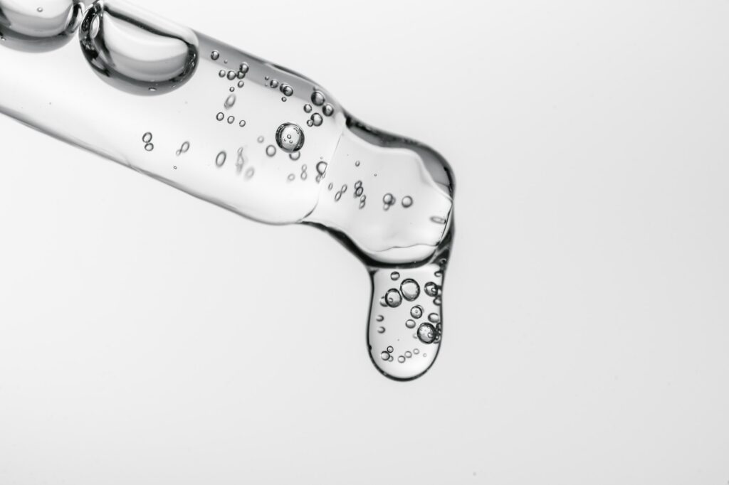 Transparent pipette with cosmetics on a white isolated background